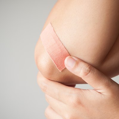 Elbow with adhesive bandage