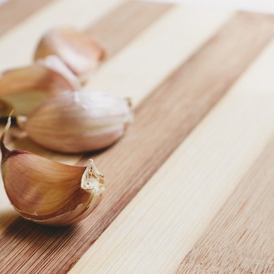 Raw garlic aloves on the cutting board