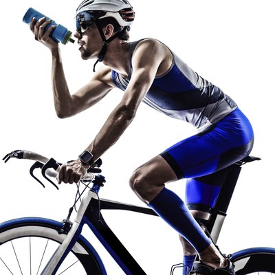 man triathlon iron man athlete cyclist bicycling drinking