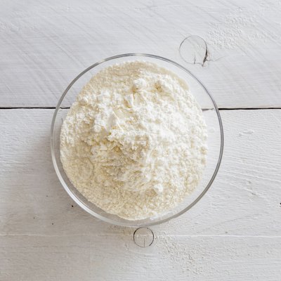 Flour in a bowl on wooden table