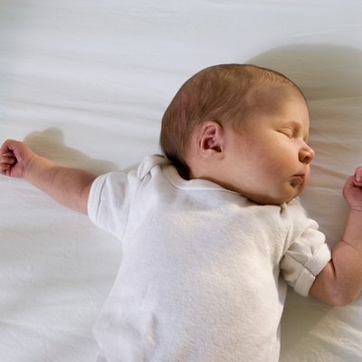 Newborn baby sleeping on the bed