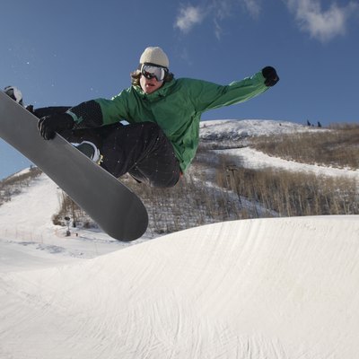 Teenage snowboarder jumping