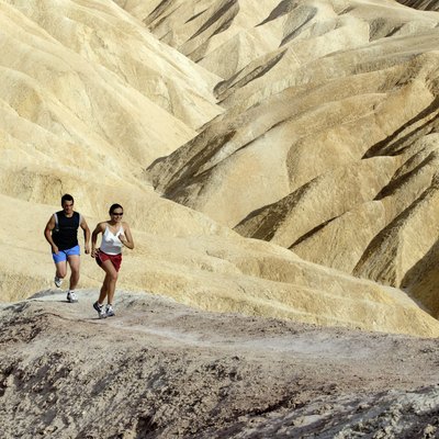 Man and woman running in desert