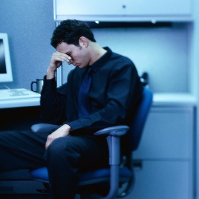 Side profile of a businessman sitting in a cubicle