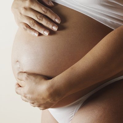 Pregnant woman touching abdomen