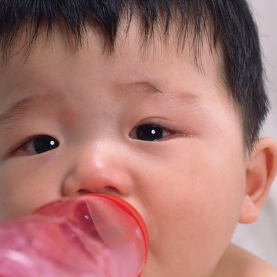 Close up of babys face, drinking milk, front view, portrait, Full Frame