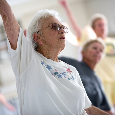 Woman exercising with others