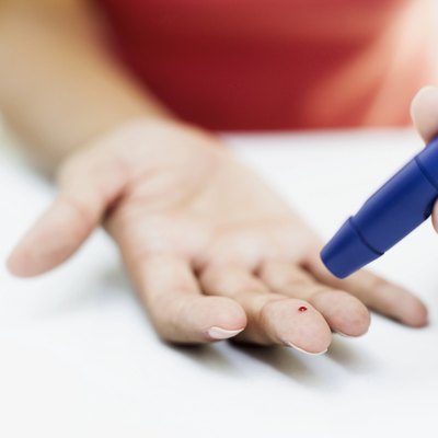 close-up of a person's hand taking a blood test