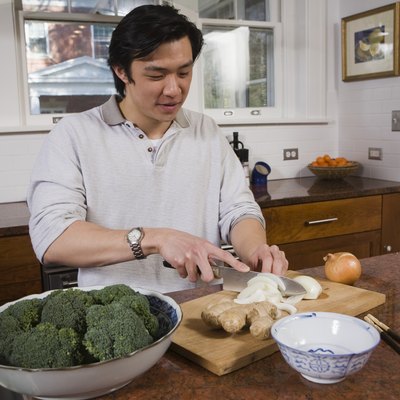 Man cutting vegetables in the kitchen