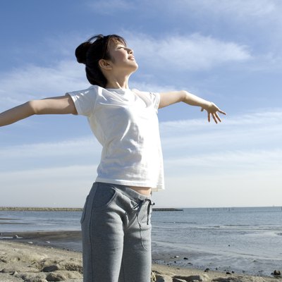 Young Woman Stretching Out Her Arms, Low Angle View, Side View