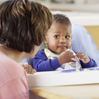 Baby eating in high chair
