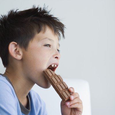 Boy eating chocolate bar