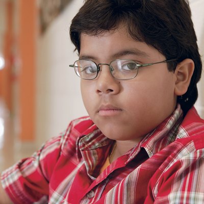 Boy sitting in school hallway
