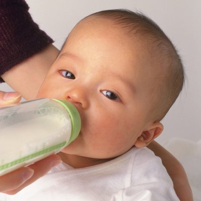 Mother feeding baby boy, portrait, side view