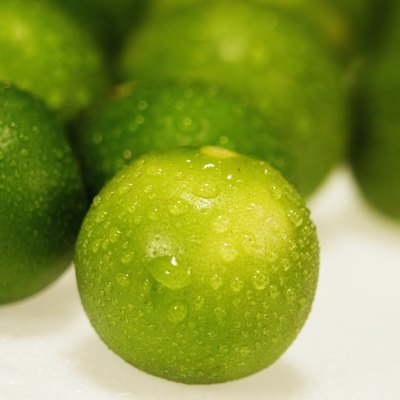 Close-up of water drops on limes