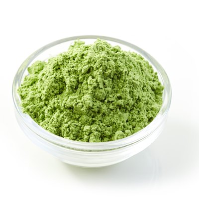 bowl of green wheat sprouts powder