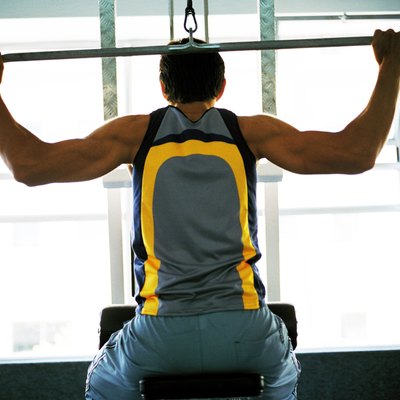 Rear view of a young man exercising on an exercise machine