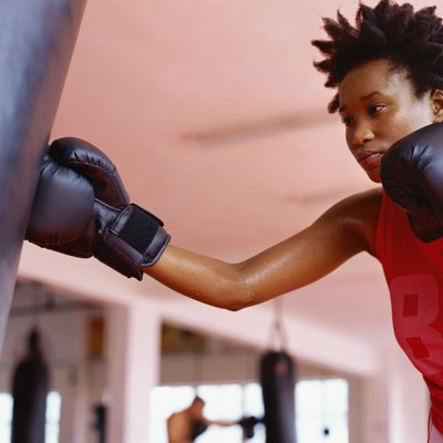 Low angle view of a young woman practicing boxing