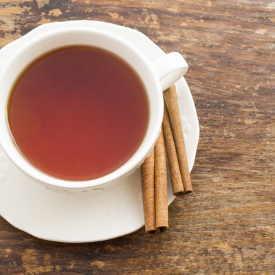 Cup of tea with cinnamon on a wooden surface