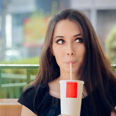 Young Woman Having a Summer Refreshing Drink Outside