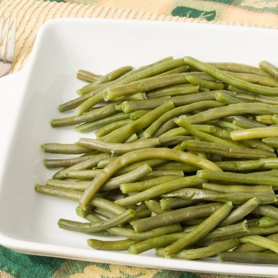 beans in casserole dish with Thanksgiving tablecloth