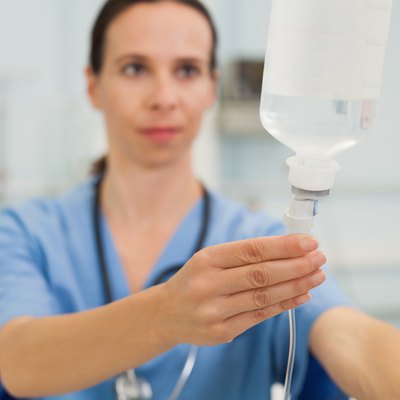 Nurse adjusting drip