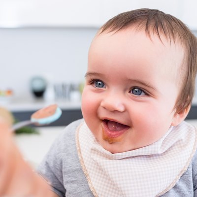 Baby boy being fed by mother