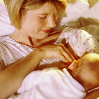High angle view of a mother breastfeeding her baby boy