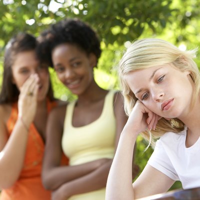 Teenage girls whispering gossip