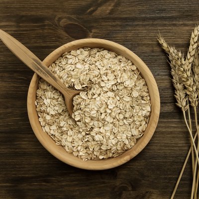oatmeal flakes in a wooden bowl with a spoon