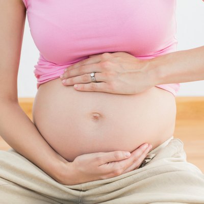 Pregnant woman holding her bump