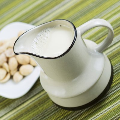 Almond milk in pourer with Almonds