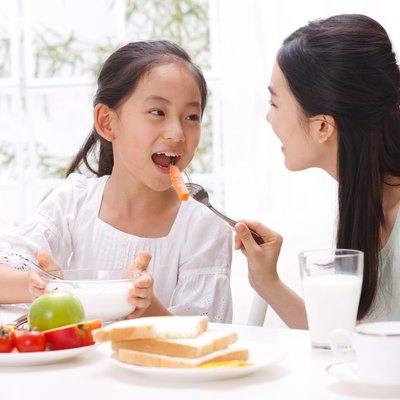 Mother and daughter having breakfast