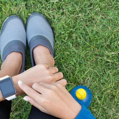 athletic woman using smartwatch on top view