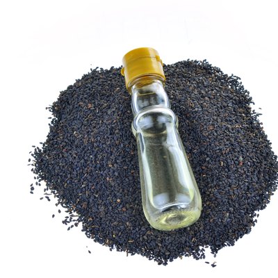 Black sesame seeds on a white background