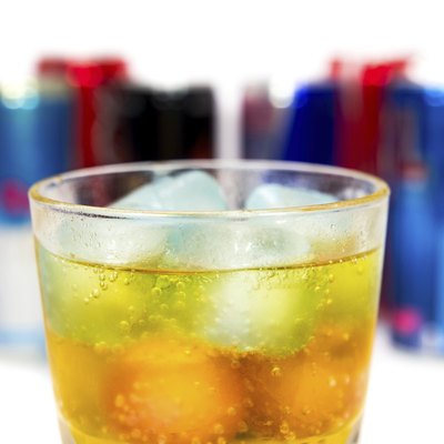glass with ice and energy drinks on the background
