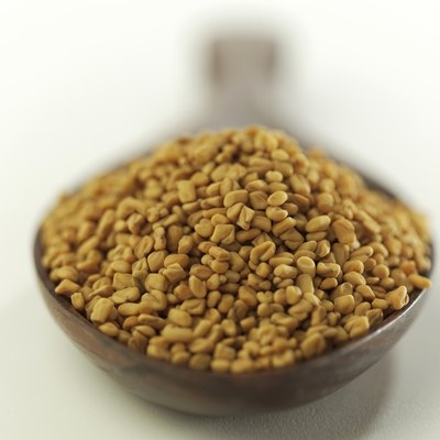 Indian spices-Fenugreek in wooden spoon.