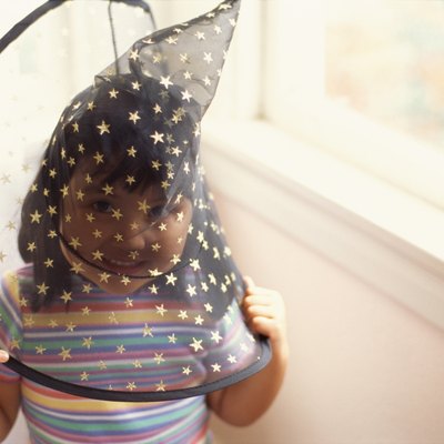 Girl wearing funny hat near window
