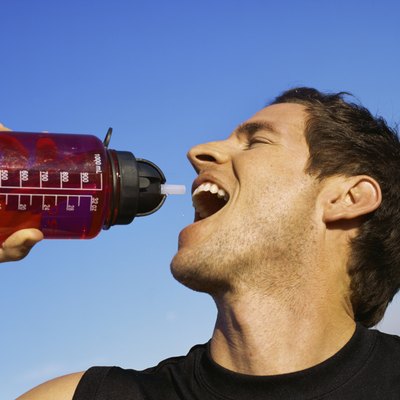 Side profile of a mid adult man drinking an energy drink