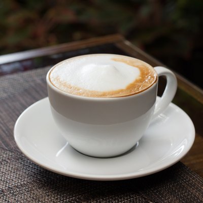 Cup of cappuccino over wooden table