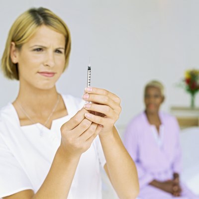 close-up of a female nurse holding a syringe