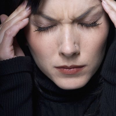 Close up of woman rubbing temples