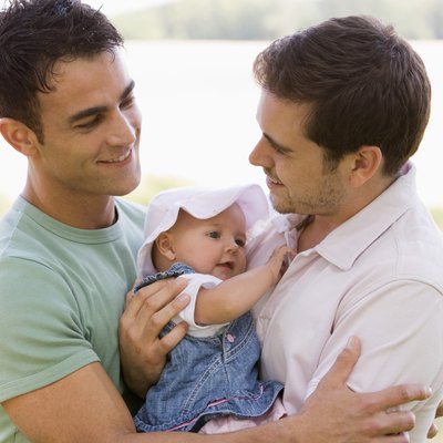 Smiling men with baby