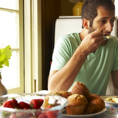 Young man eating breakfast