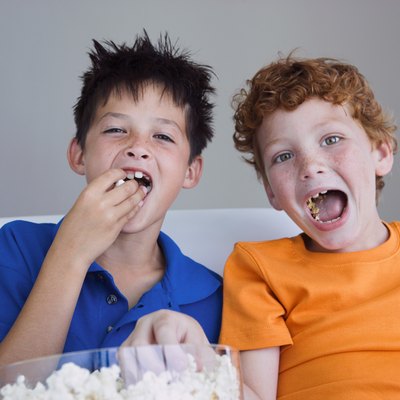 Boys sharing popcorn