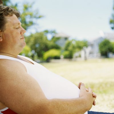 side profile of a mid adult man leaning against a tree