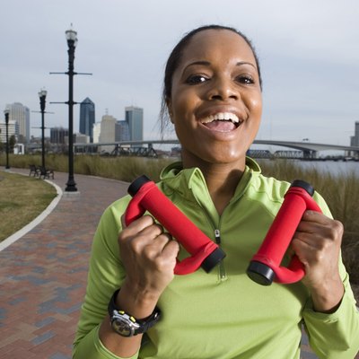 Portrait of a young woman in sports clothing jogging on walkway