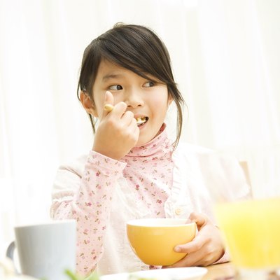 Young girl eating breakfast