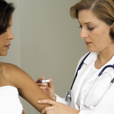 Woman doctor giving patient injection