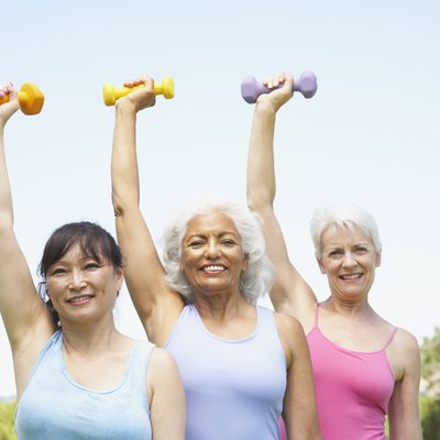 Multi-ethnic senior women lifting weights